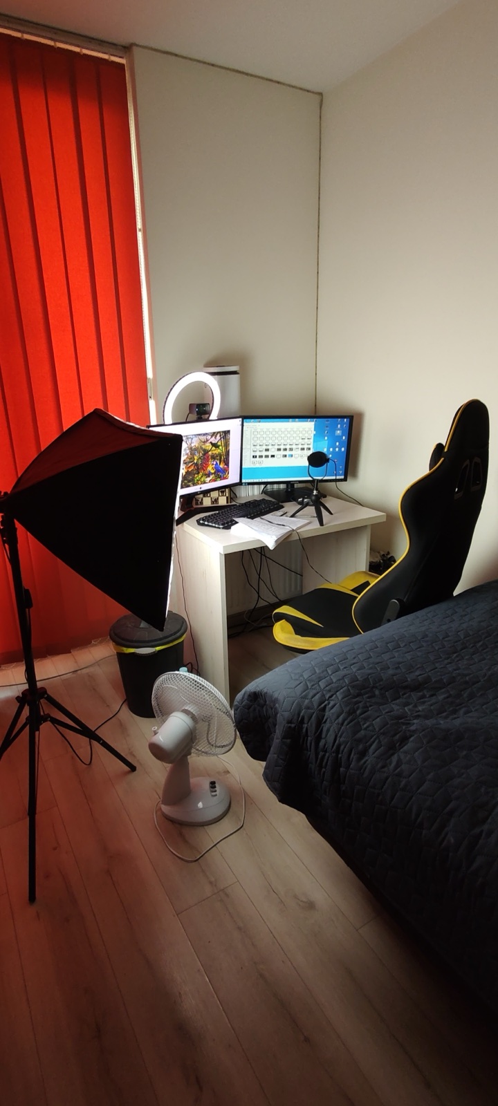 The first recording setup: a small desk, a softbox and a bed